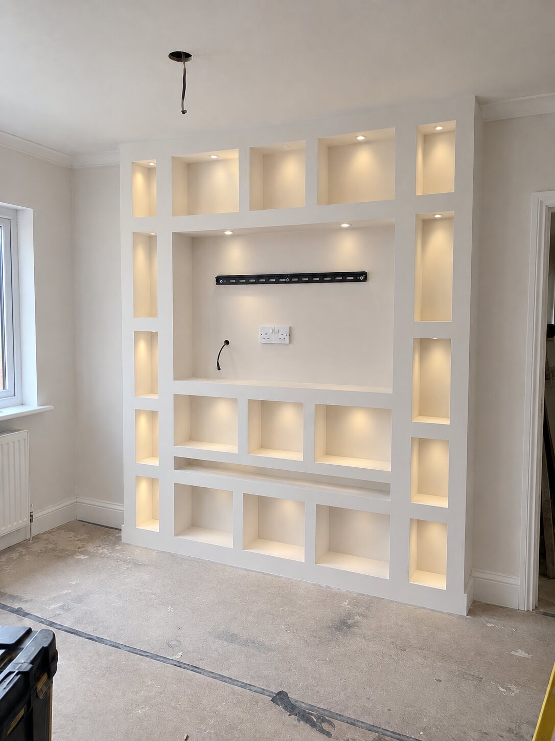 Full-height media wall with lit alcoves, Southport after